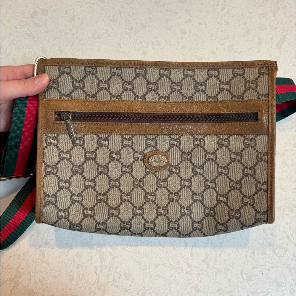 Gucci Plus hard coated canvas and leather clutch with unbranded strap.
